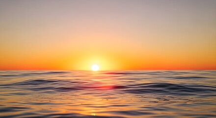 Obraz premium A serene sunset over the ocean with gentle waves reflecting the golden light of the sun as it dips below the horizon in a calm and peaceful atmosphere