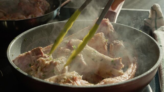 The process of cooking lamb in a pan with spices. The heat creates steam as the meat is turned and cooked thoroughly to enhance the flavor.