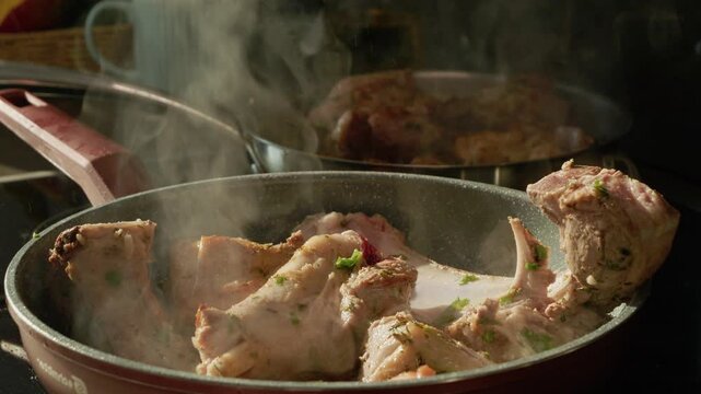 Lamb is cooked in a pan with spices. Steam rises as the meat sizzles, creating a nice aroma. This shows how to prepare delicious lamb for a meal.