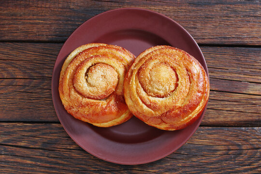 Two fresh sweet buns on plate