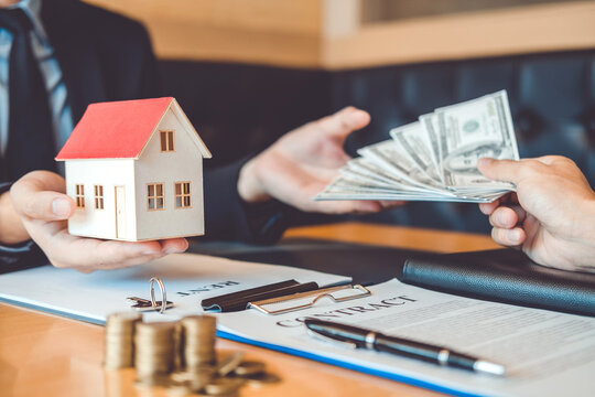 Sale agent giving house to customer and sign agreement contract, Insurance Home concept