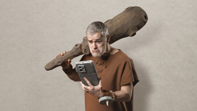 Confused Caveman Holding a Primitive Stone Smartphone and Wooden Club