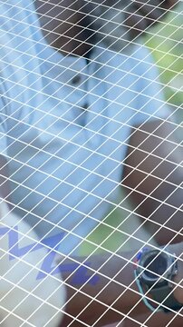 Vertical video: Senior man adjusting wrist behind white mesh, revealing blue-strap watch for health