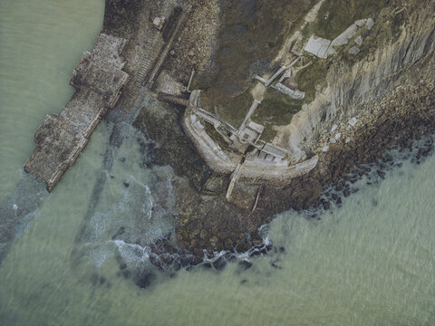 Aerial view of blockhaus stutzpunkt 221 arnika on the cliff overlooking the beautiful coastline and waves of the ocean, Boulogne-sur-Mer, Pas-de-Calais, France.