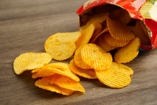 Potato chips in open bag, delicious BBQ seasoning spicy for crips, thin slice deep fried snack fast food.