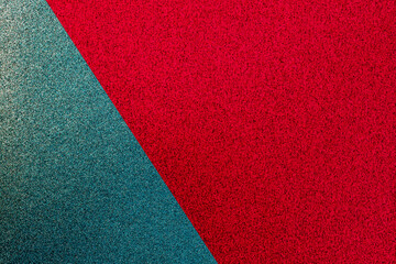 Fototapeta premium Colorful texture reveals a mix of red and teal surfaces with a smooth finish creating an interesting visual display