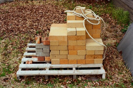 Stacked Fire Bricks on a Wooden Pallet Outdoors