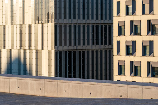Minimal modern architecture facade of concrete building with shadow and sunlight defining geometry and pattern on clean urban exterior detail