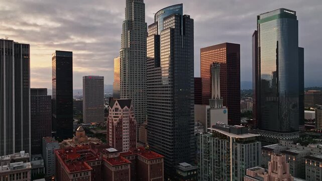 Air view over downtown Los Angeles. Los Angeles skyscrapers from sky. Flying above LA cityscape. Aerial view of downtown LA. Urban LA from drone angle. Los Angeles skyline wide aerial.