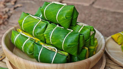 Khao Tom Mud or banana in sticky rice in fresh green banana leaf before cooking, popular dessert recipe in Thailand. © Chaaim