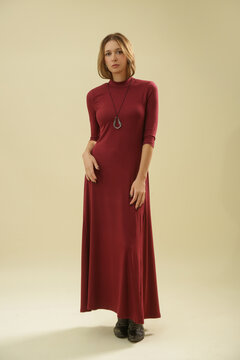 Studio Fashion Portrait of Woman in Burgundy Cotton Maxi Dress with Roll Neck and Three Quarter Sleeves
