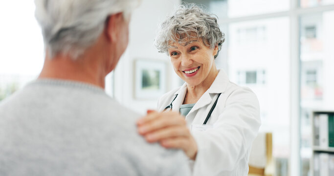 Consultation, healthcare and doctor with senior woman in hospital for advice in discussion. Happy, professional and medical worker with elderly female patient for help at checkup in clinic office.