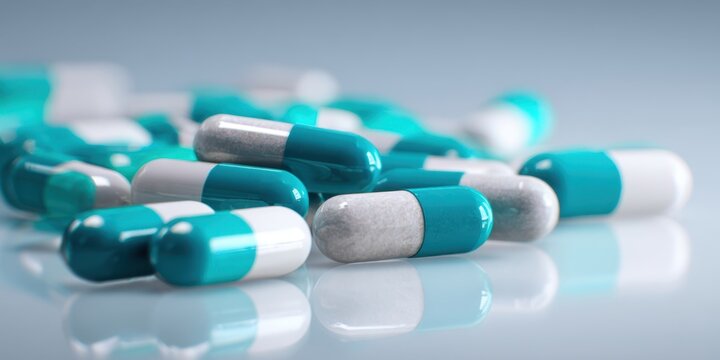 The Capsules Lying on a Reflective Surface with Soft Focus Medical Background