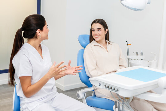 Dentist consulting with patient about dental treatment options in a modern dental clinic