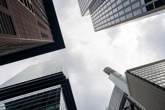 Urban skyscraper in Frankfurt Bankenviertel shows financial architecture and strong perspective while sky clouds create calm copyspace