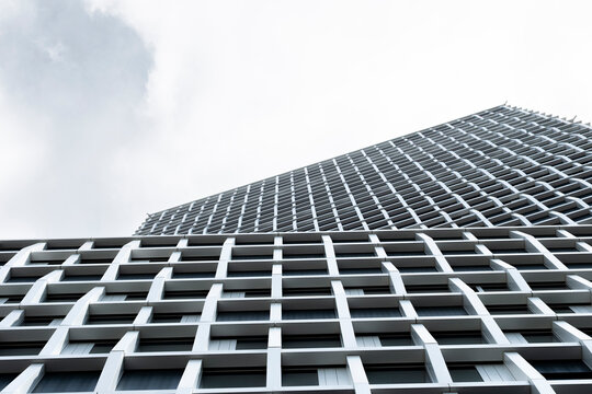 Architecture building facade in modern minimal grid composition uses perspective lines to open sky clouds and generous copyspace clean background