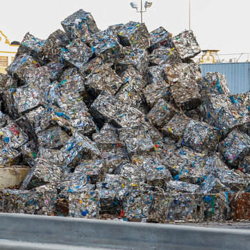 Compressed recyclable material stacked in bales at recycling facility