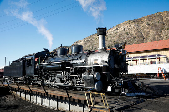 Historic steam locomotive at rail yard