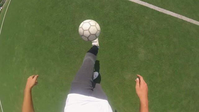 Football player skillfully dribbling ball on vibrant green turf, showcasing dynamic footwork and control, capturing the essence of athleticism and movement in a continuous action sequence