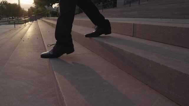 Business man climbing stairs symbol of progress. Businessman taking confident stairs steps. Business man walking stairs toward future career. Businessman climbing stairs with ambition.