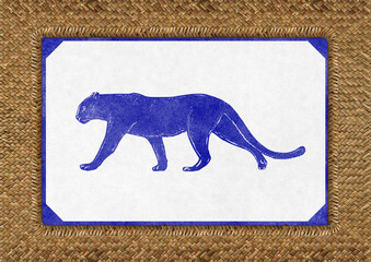 Vintage panther illustration in blue ink on textured paper with decorative border, placed on woven straw background. Minimalist safari-style animal poster. © Lisa