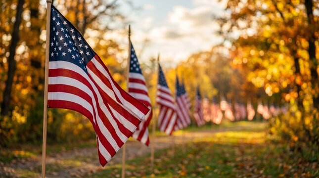 Many American flags line a beautiful autumn path bathed in warm sunlight with colorful fall leaves