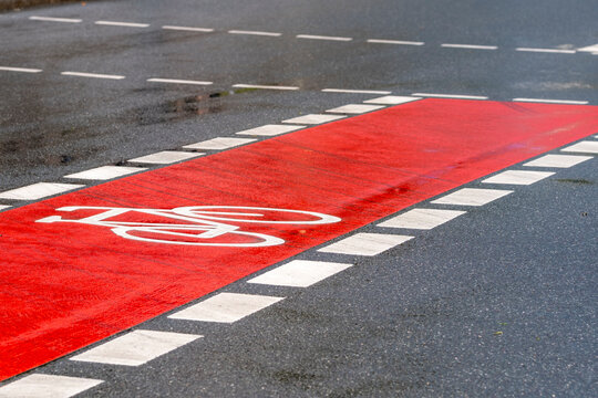 Bicycle lane symbol and pavement markings on urban roadway street communicate mobility and safety supporting active transport and city planning