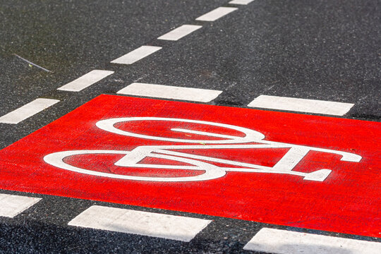Urban roadway street features bicycle lane symbol with pavement markings expressing mobility safety and modern cycling route for everyday transport