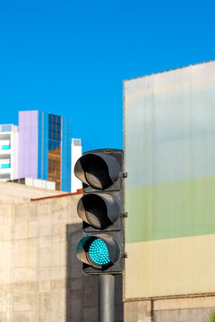 Traffic signal light turns green at urban intersection giving street roadway control and safety for smoother movement and city transport flow