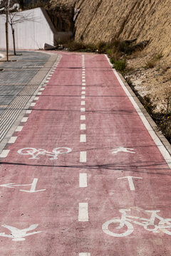 Urban street roadway shows bicycle lane pavement markings and symbol expressing mobility safety and modern cycling infrastructure for daily transport