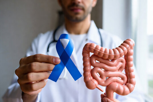 A doctor is holding a blue awareness ribbon alongside a model of the intestines, representing colorectal cancer.