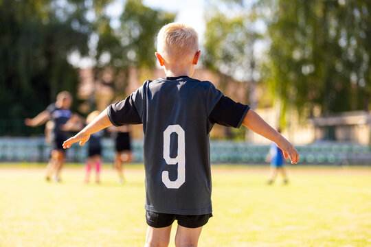 Little Boy Playing In Soccer Jersey in Sunny Day. Kids Playing in Football League. Boy in Soccer Blue Jersey With Number Nine