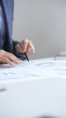 Obraz premium Professional businessman reviewing financial data, analyzing charts and graphs, using laptop, making strategic decisions for business growth. Business people concept