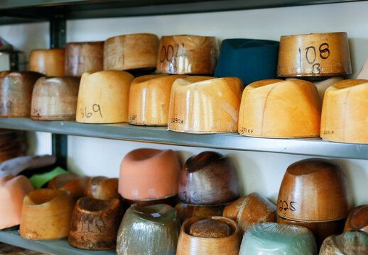 Hat blocks on shelves in millinery studio