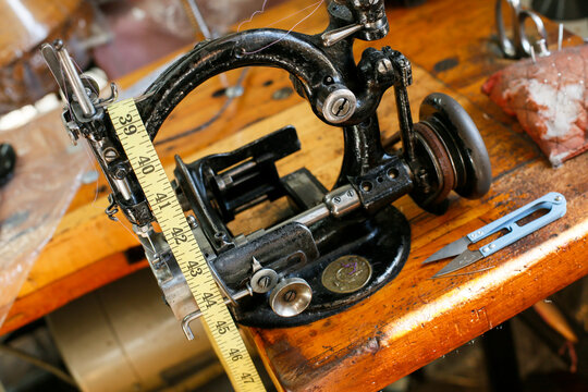 Vintage sewing machine with measuring tape on worktable