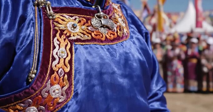 Traditional Mongolian blue deel robe with gold embroidery at festival