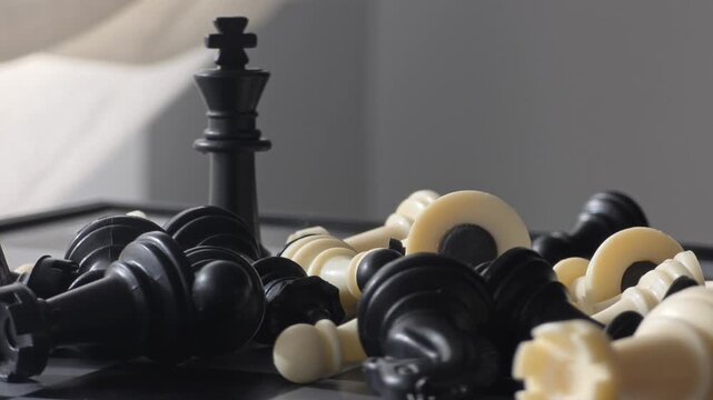 Black King Victorious Over Fallen Pieces - Strategic Dominance