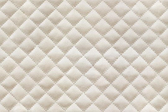 Diamond-stitch seamless texture pattern in beige upholstery suede for furniture, cushions, or wall decor as background