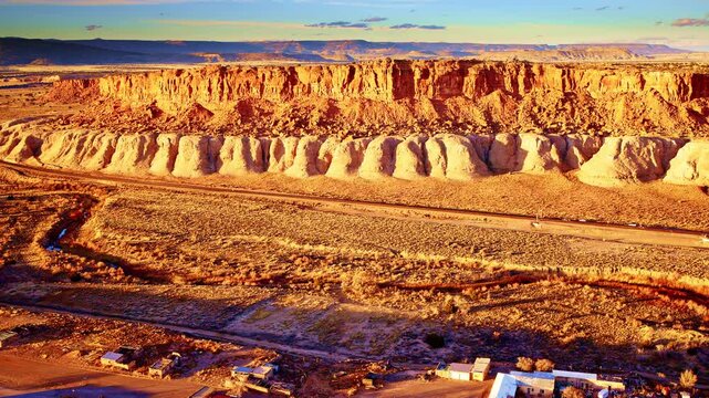 Drone shot of red mesa outcrop in a dramatic New Mexican landscape.
