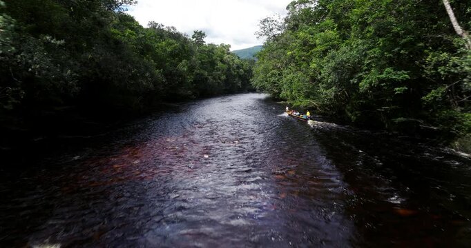 Tourists On Motorboat Sailing On Churun River Through Rainforest In Canaima National Park, Venezuela. tracking drone shot