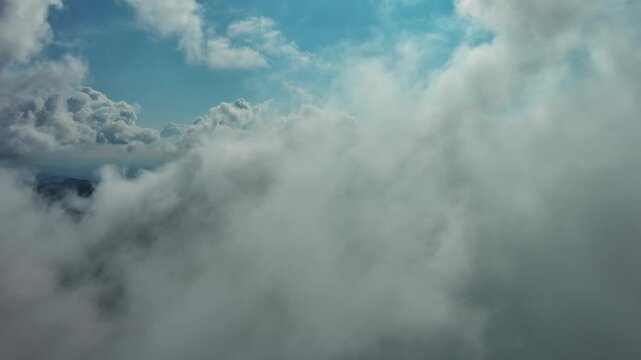 Aerial high view of clouds and blue sky, flying in clouds, 4k