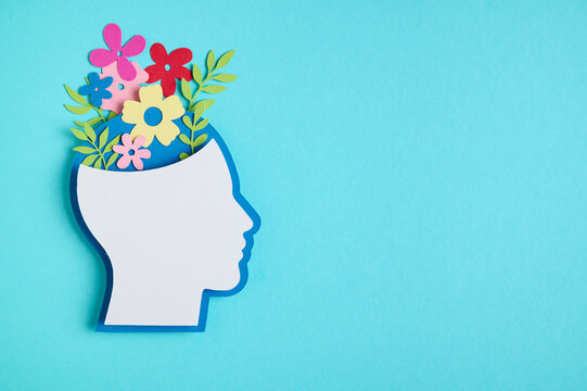 Mental health concept featuring a head silhouette and a flowers blooming