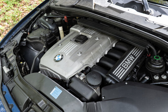 Zurich, Switzerland, April 17, 2026. Top view of a silver BMW N52B30 3.0 liter inline-six petrol engine bay in a blue metallic vehicle