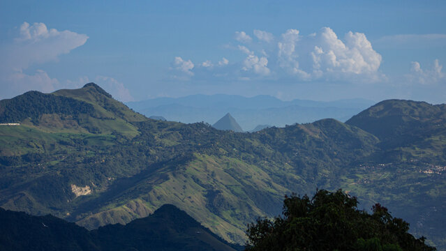 View of Cerro Tusa, the tallest natural pyramid in the world, located in the municipality of Venecia in Colombia, a hill almost 2,000 meters high. And in the view there are also imposing mountains and