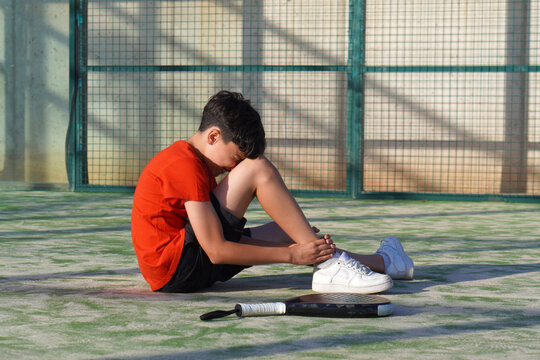 padel sport concept. faceless child injured during a padel match
