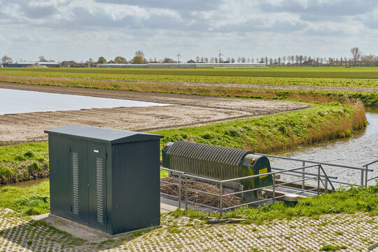 Waterbeheer En Landbouw In Nederland Met Een Gemaal En Elektrische Kast In Een Polderlandschap Onder Een Bewolkte Hemel