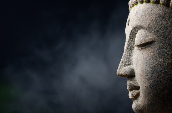 Side profile of a stone Buddha head statue, tranquility and mental focus concept