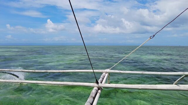 Tropical sea and clouds, view from moving traditional boat, 4k