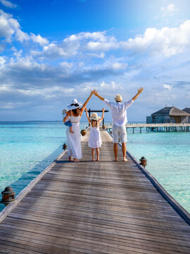 Rear view of a happy family enjoying their tropical holidays in the Maldives islands as a concept for travel and vacations