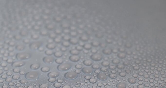 wet blue smooth plastic material for gifts and bouquets, covered with water droplets smooth blue synthetic material, waterproof material